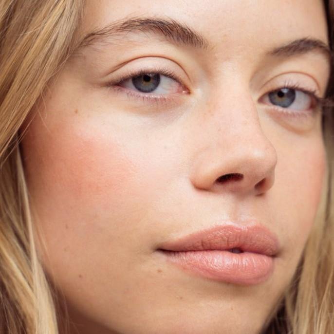 A model shot of LO Care's Flo Lip Balm