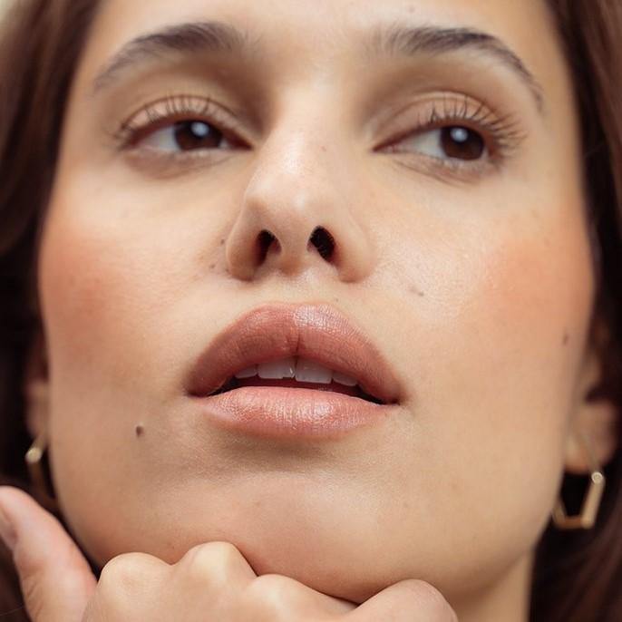 A model shot of LO Care's Flo Lip Balm