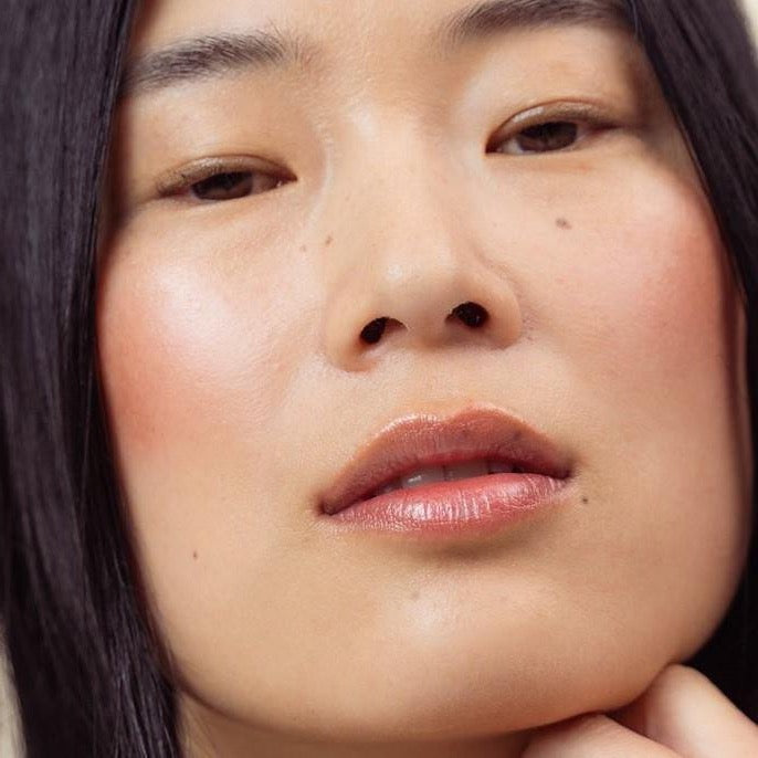 A model shot of LO Care Lip & Cheek Balm Velvet