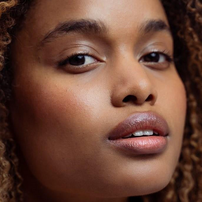 A model shot of LO Care Lip & Cheek Balm Velvet